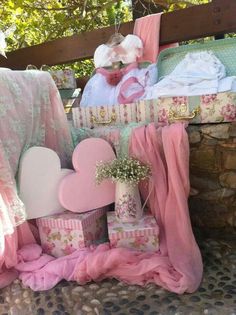 pink and white items are stacked on top of each other in front of a stone wall