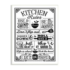 the kitchen rules poster is hanging on a wooden wall, with black and white lettering