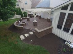 an outdoor patio with seating area and fire pit