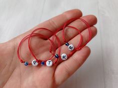 This listing is for 1 red bracelets. The  bracelet is made with a cotton thread slim red string, 1 plastic bead with letter and 1 blue plastic bead. Easily adjustable by moving the knots closer or away. This red string bracelet will help to protect you. This bracelet is made for guard against the evil eye. The bracelet is unisex with adjusted length.   Please select a size! Size of the element letter made of steel: 4 x7 x1 mm Please select the letter you want! Personalized Red Beaded Bracelets With Letter Beads, Handmade Red Bracelets For Birthday, Personalized Red Letter Beads Bracelet, Adjustable Red Beaded Bracelets For Personalized Gift, Red Custom Name Bracelet For Friendship, Red Adjustable Jewelry For Personalized Gift, Adjustable Red Jewelry For Personalized Gifts, Baby Letters, Red Bracelet