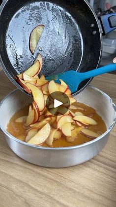 someone is pouring apple slices into a pan