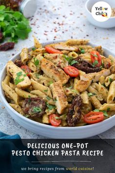 a white bowl filled with pasta covered in meat and veggies on top of a table