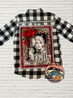 a black and white checkered shirt with an image of dolly on the front in red