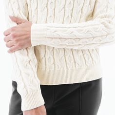 Introducing a modern, feminine version of the classic fisherman's sweater: the Fischer Sweater! While this sweater nods to tradition with beautiful alternating rows of cable knit along the body and by utilizing wool, small details bring this style into 2023. First and foremost, we love the enhanced softness and more pleasant handfeel of the knit, which is a blend of luxurious merino wool and acrylic. The length of the sweater is also very flattering and feminine, hitting right at the hip. The mo Fitted Chunky Knit Sweater In Winter White, Elegant Cable Knit Winter Sweater, Fitted Classic Chunky Knit Sweater, Fitted Classic Sweater In Winter White, Classic Fitted Winter White Sweater, Fitted Classic Winter White Sweater, Classic Fall Cable Knit Sweater, Classic Cable Knit Sweater For Fall, Elegant Cable Knit Turtleneck Sweater