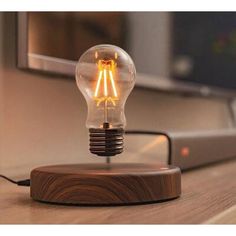 a light bulb sitting on top of a wooden table