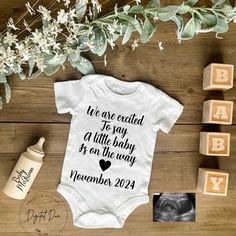 a baby's bodysuit with the words we are excited to say a little baby is on the way