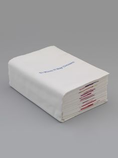 a stack of papers sitting on top of each other in front of a gray background