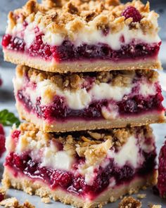 raspberry cheesecake bars stacked on top of each other