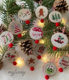 christmas ornaments hanging from pine cones on a table