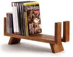 a wooden shelf with books and magazines on it