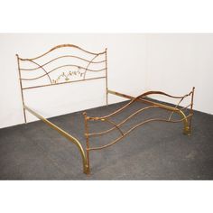 a metal bed frame sitting on top of a carpeted floor next to a white wall