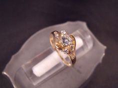 a diamond ring sitting on top of a clear case