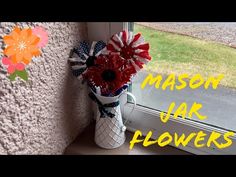 a vase filled with flowers sitting on top of a window sill next to a flower pot