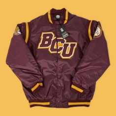 🧥 Bethune Cookman School Jacket is a stylish and comfortable jacket ideal for Bethune Cookman University students, alumni, and fans. This jacket is made of high-quality materials and comes in a classic yellow and maroon color scheme with the Bethune Cookman logo embroidered on the front in bold white lettering. 🧥 The bomber jacket is designed for both style and functionality, with a button-up front, ribbed cuffs and hem, and a soft, comfortable lining. The jacket also gives you convenience all Collegiate Outerwear With Ribbed Cuffs For Campus, Fall Varsity Outerwear For Fan Gear, Fall Varsity Outerwear Fan Gear, Varsity Fan Gear Outerwear For Fall, Collegiate Winter Varsity Jacket For Fans, Winter Collegiate Varsity Jacket For Fan Gear, Collegiate Varsity Jacket For Winter Fan Gear, Collegiate Long Sleeve Outerwear For College, Collegiate Varsity Jacket For Fan Gear In Winter