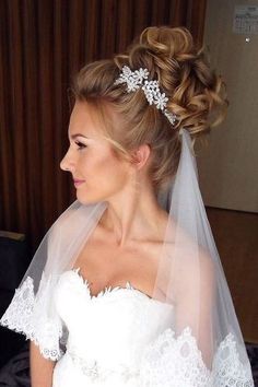 a woman in a wedding dress with a veil on her head