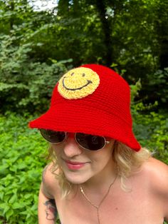 Lightweight acrylic hat, perfect for festivals, summer & transition. Super fun, stand out with this hat!  Hand crocheted by Abi, made with love. Available in black, green and pink. Check out my shop for more. ACRYLIC BUCKET HAT - Material: 100% Repurposed Acrylic - Quality and Sustainability: Handmade ∙ Slow Fashion SIZING - One Size, each product is unique so might vary slightly in size. Measures are based on the average size 22 inch circumference.  CARE INSTRUCTIONS - Hand Wash Cold Dry Flat. Crochet Fun Hats, Summer Transition, Bob Chapeau, Crochet Bucket Hat, Smiley Faces, Black Crochet, Bucket Hats, Smiley Face, Hand Crochet