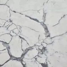 white marble with cracks in it and the words calacatta lago written below