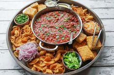 a platter filled with chips and salsa