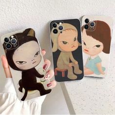 three phone cases with cartoon characters on them, one has a cat and the other is a monkey