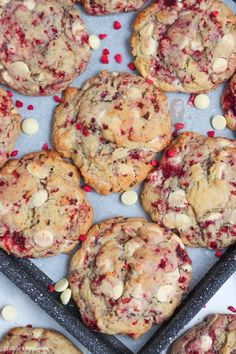 cookies with white chocolate chips and cranberries on a baking sheet, ready to be eaten