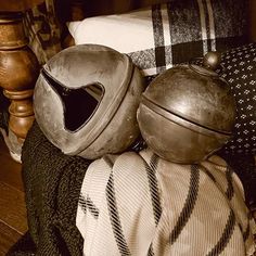 two helmets sitting on top of a pile of blankets