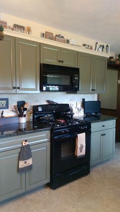 a black stove top oven sitting inside of a kitchen