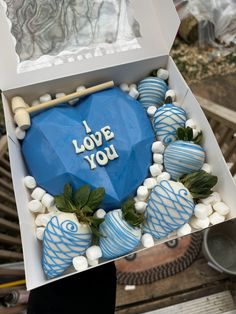 a box that has some blue and white items in it with the words i love you on it