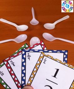 five spoons and four cards with numbers on them