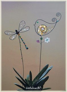 three dragonflys are sitting on top of a plant