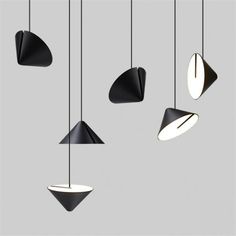 five black and white lights hanging from the ceiling, with one light on each side