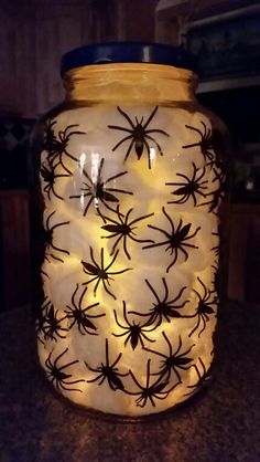 a lighted jar with spider webs on it