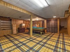 an empty room with a pool table in it