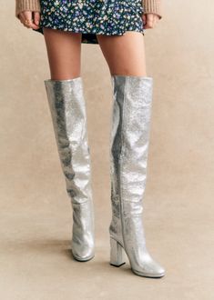 High-heeled thigh high boots;Made in our Portuguese atelier;Interior zip fastening system;Embossed metallic leather exterior;Leather lining and insole;Leather and rubber outsole;Leather-covered heel;Heel height: 11 cm / 4.3 in;Platform height: 1 cm / 0.4 in;Tone-on-tone metal zip Silver Knee High Boots, Atelier Interior, Fall Footwear, Online Stylist, Silver Boots, Metallic Boots, Technology Fashion, Celebrity Lifestyle, Metallic Heels