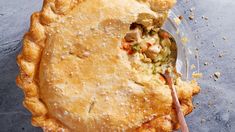 a close up of a pie on a plate with a spoon