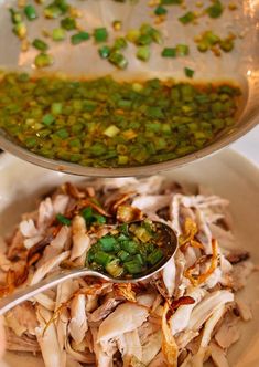 a bowl filled with meat and peas next to another bowl full of green beans on the side