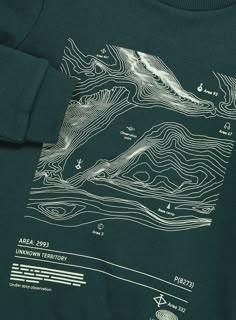 a green t - shirt with a map on it