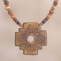 Signifying a union between the spiritual and the corporeal a pre-Hispanic chakana cross in yellow is crafted of ceramic to center this necklace from Peru. Dina designs the necklace adorning the wearer with earth-tone ceramic and gold-tone beads closing with a fold-over clasp of sterling silver. Necklace Sun, Travel Necklace, Beaded Pendant Necklace, Ceramic Pendant, Ceramic Jewelry, Ceramic Beads, Beaded Pendant, Peru, Halloween Decorations