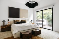 a bedroom with a large bed and sliding glass doors