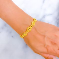 This 22k gold bracelet features a lovely decorative design that blends elegance with intricate craftsmanship. Weighing 9.0 grams, the bracelet showcases a lustrous yellow gold finish and measures 7.5 inches in length, with adjustable 1.4-inch links for a tailored fit. The secure hook lock ensures both style and ease of wear. The detailed, ornate design adds a touch of sophistication, making this bracelet a perfect choice for those who appreciate refined beauty and timeless charm. Ideal for both everyday elegance and special occasions. PRODUCT DETAILS Gold Purity(karat): 22k Gold Weight(grams): 9.0 Item Finish: Yellow Gold Bracelet Length: 7.5" Adjustable Links: 1.4" Links Lock Style: Hook Lock Gold-plated Bracelet With Intricate Design, Adjustable Intricate Design Gold Bracelet, Gold Plated Bracelet With Intricate Design, Gold-plated Bangle Bracelet With Intricate Design, Gold Plated Bangle Bracelet With Intricate Design, Gold Plated Bangle With Intricate Design, Elegant Adjustable 22k Gold Bangle, Gold-plated Bracelets With Intricate Design, Adjustable Yellow Gold Bracelet With Intricate Design