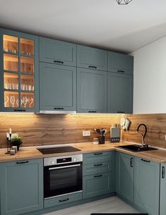 a kitchen with blue cabinets and wooden counter tops