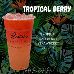 a tropical drink with raspberry and strawberries on the side, surrounded by leaves