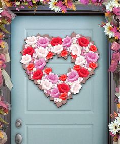 a heart made out of flowers on a door