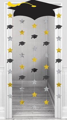 graduation decorations hanging from the ceiling in front of an open door with stars and a graduate cap on it