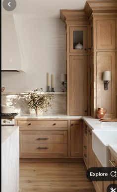 a kitchen with wooden cabinets and white counter tops