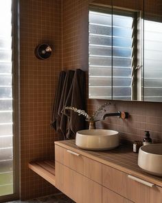 a bathroom with two sinks and mirrors in it