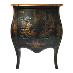 an ornate black and gold painted cabinet with drawers on one side, decorated with flowers and birds