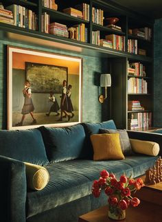 a living room filled with furniture and bookshelves