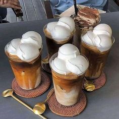 there are four cups with ice cream on them