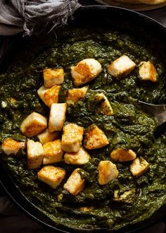 a pan filled with spinach and tofu