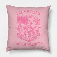 a pink pillow that says i buy books like i'm immortal